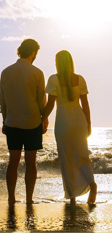 A couple on a beach during their honeymoon