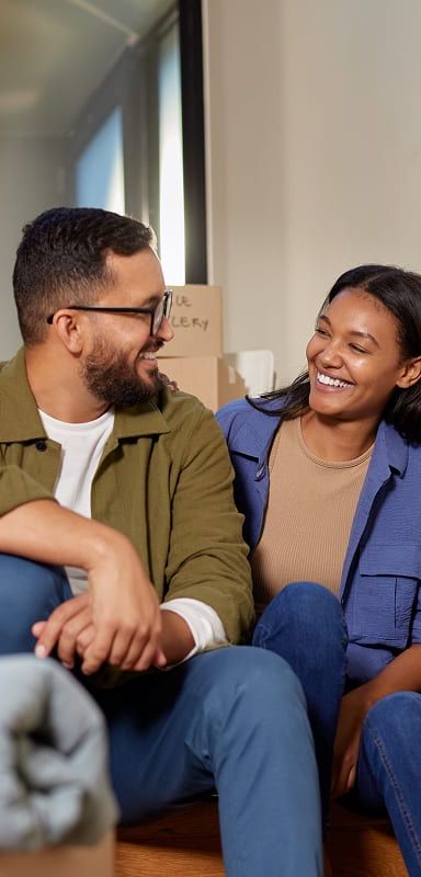 A couple on the steps surrounded by boxes