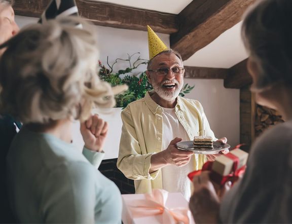 A group surprising a man at a birthday party