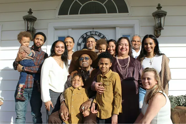 Three generations gathered on a front porch
